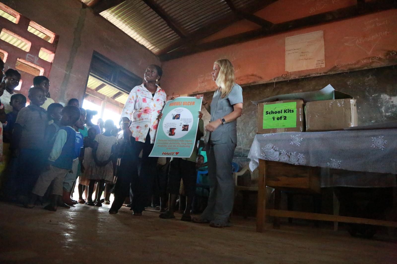 HART volunteers and local teachers presenting school health kits together