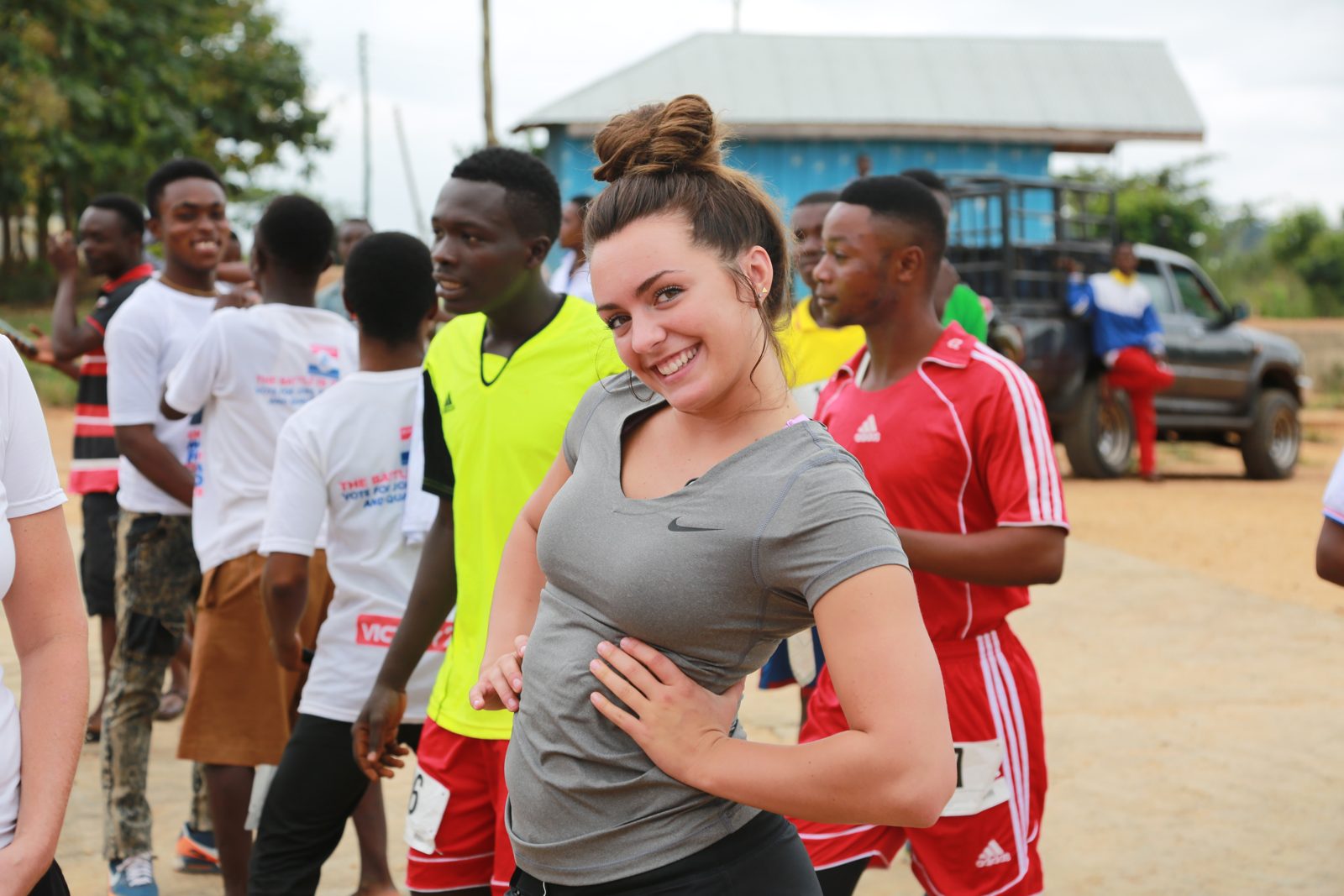 A volunteer laughing with runners near the line