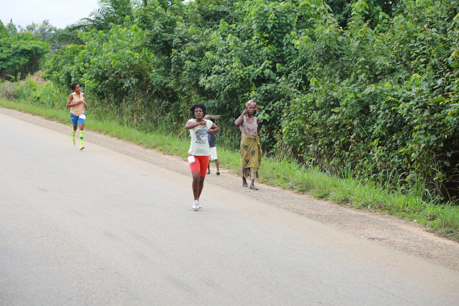 Two runners pacing each other down the road