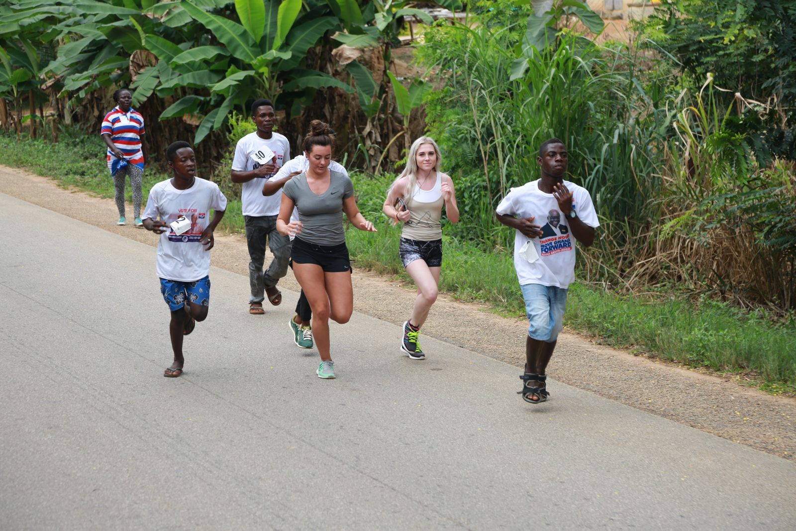 A mixed pack of runners rolling down the road