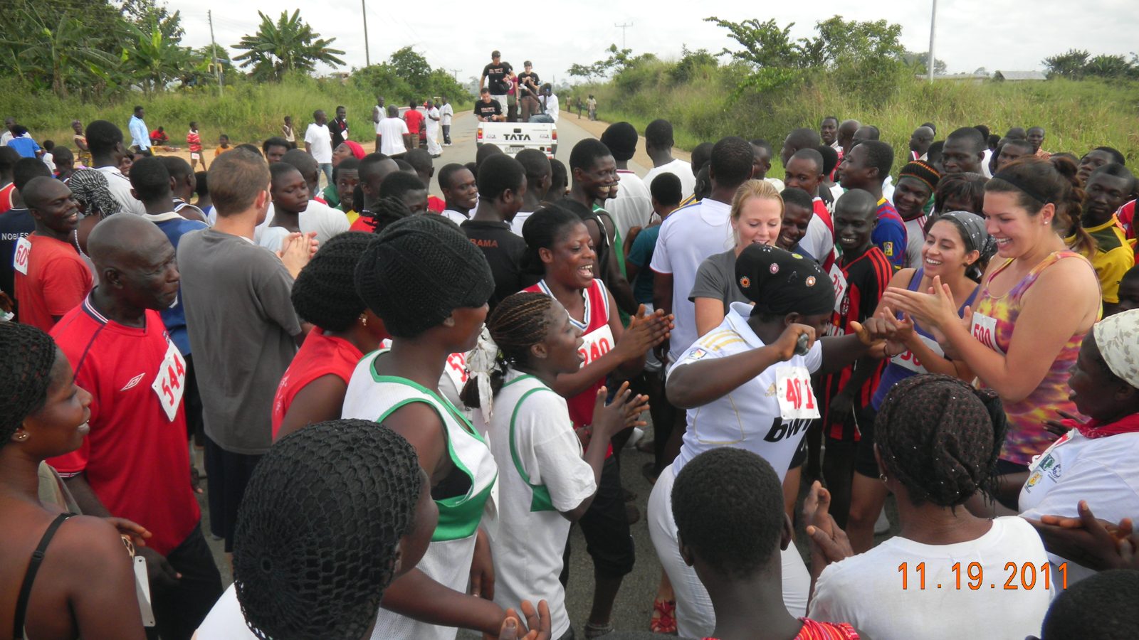 A huge crowd of runners and neighbors celebrating on the race road