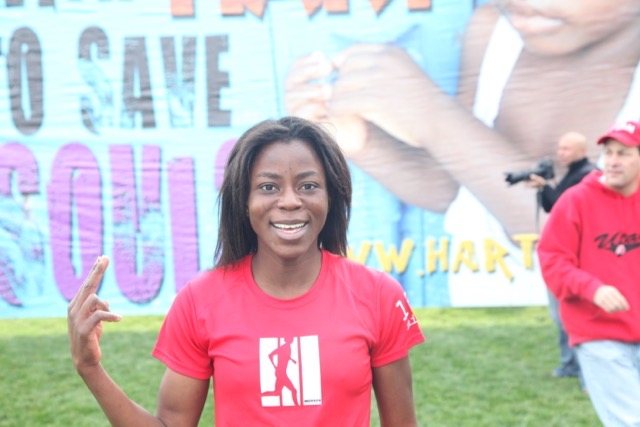A smiling volunteer at the HART billboard